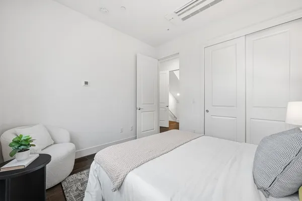 a bedroom with a bed and a couch