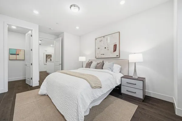 a bedroom with a bed and a night stand