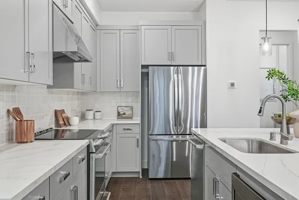 a kitchen with a sink appliances and cabinets