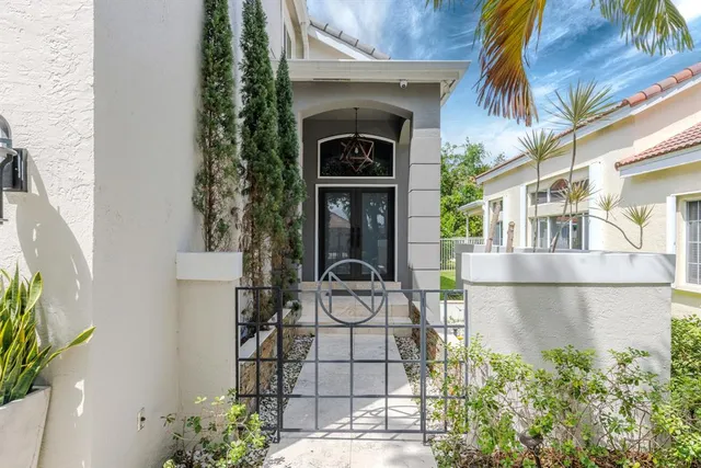 a front view of a house with plants