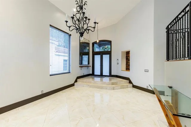 a view of a room with a chandelier and windows