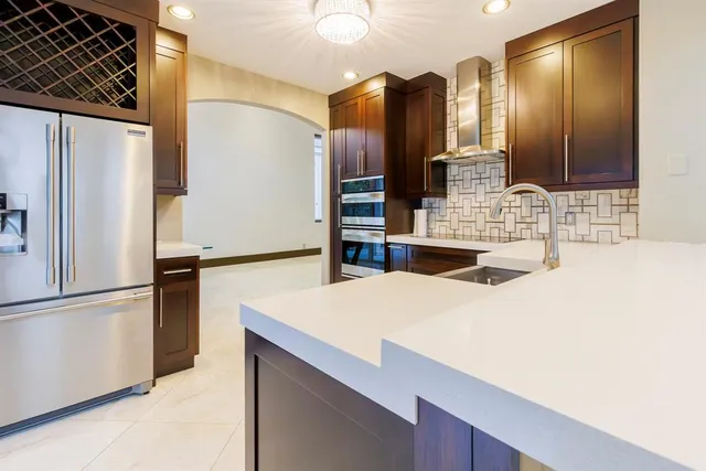 a kitchen with stainless steel appliances a refrigerator and cabinets