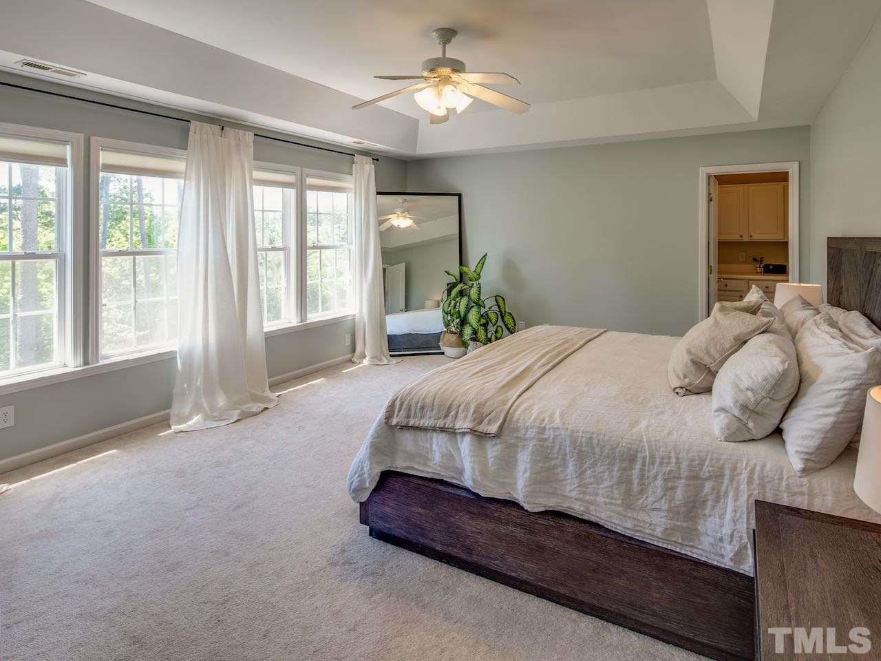 7780 Silver View Lane Raleigh, NC 27613 - Photo 10 of 30 The master bedroom is huge and it has a wonderful view of the backyard and the trees surrounding Dunnaway Pond.