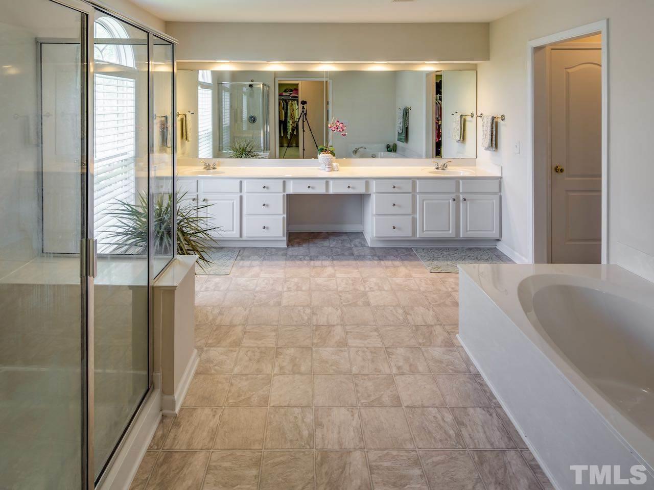 7780 Silver View Lane Raleigh, NC 27613 - Photo 12 of 30 The master bathroom has a garden tub and separate shower. And there are two walk-in closets. Praise the Lord.