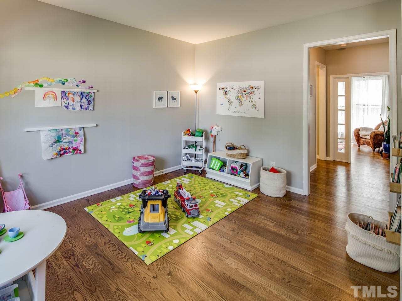 7780 Silver View Lane Raleigh, NC 27613 - Photo 18 of 30 When the house was built Pulte called this the living room. But who needs a formal living room when you have a large and open family room? What is much more practical is a playroom. Voila.