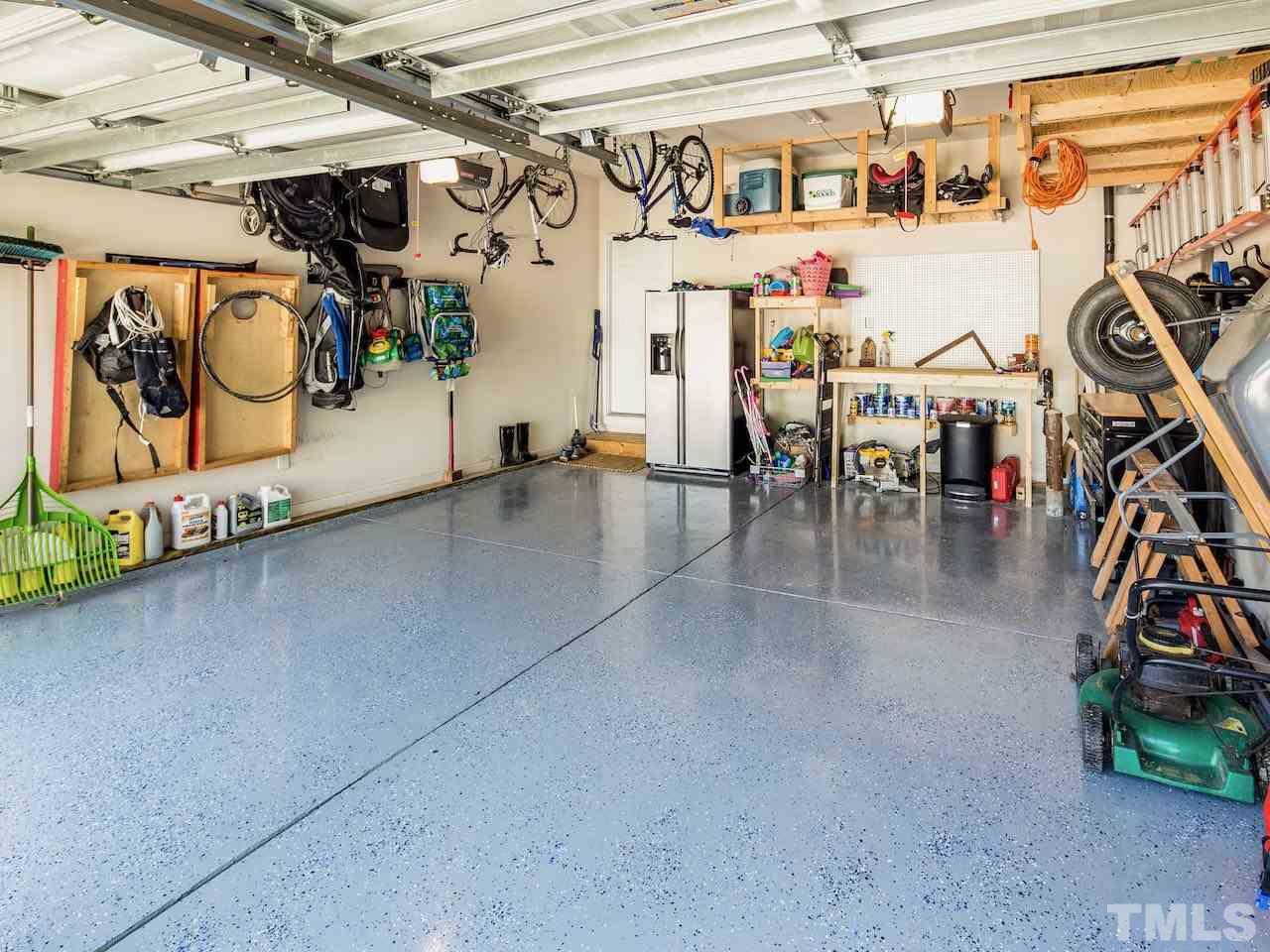 7780 Silver View Lane Raleigh, NC 27613 - Photo 24 of 30 Epoxy floor. Work bench. Built-in storage shelves. What's in your garage?