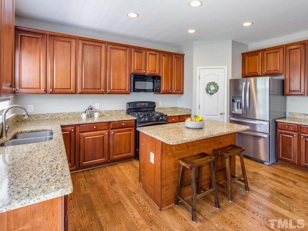7780 Silver View Lane Raleigh, NC 27613 - Photo 4 of 30 The kitchen has beautiful granite counters, gas range, large island, a plethora of cabinets, and a pantry with ample storage. If you like to cook (and entertain), you will love this kitchen!