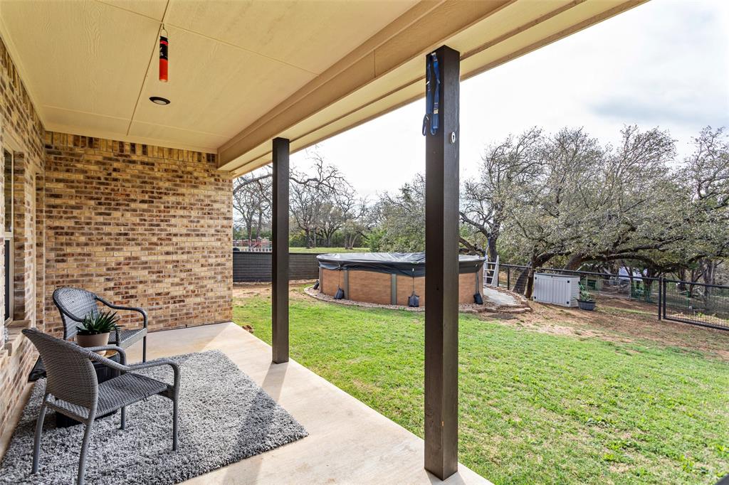 223 Cottongame Road Weatherford, TX 76088 - Photo 27 of 39 a view of a porch with furniture and a yard