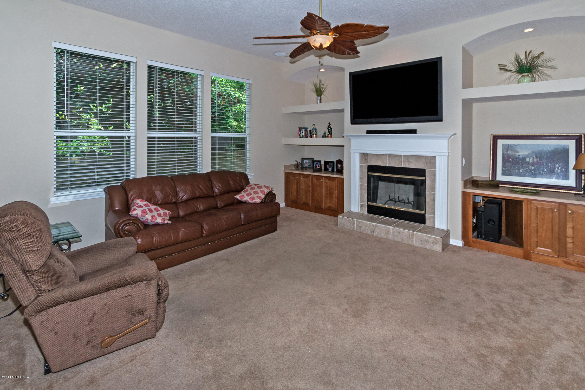 773 West Devonhurst Lane Ponte Vedra, FL 32081 - Photo 7 of 16 a living room with furniture a flat screen tv and a fireplace