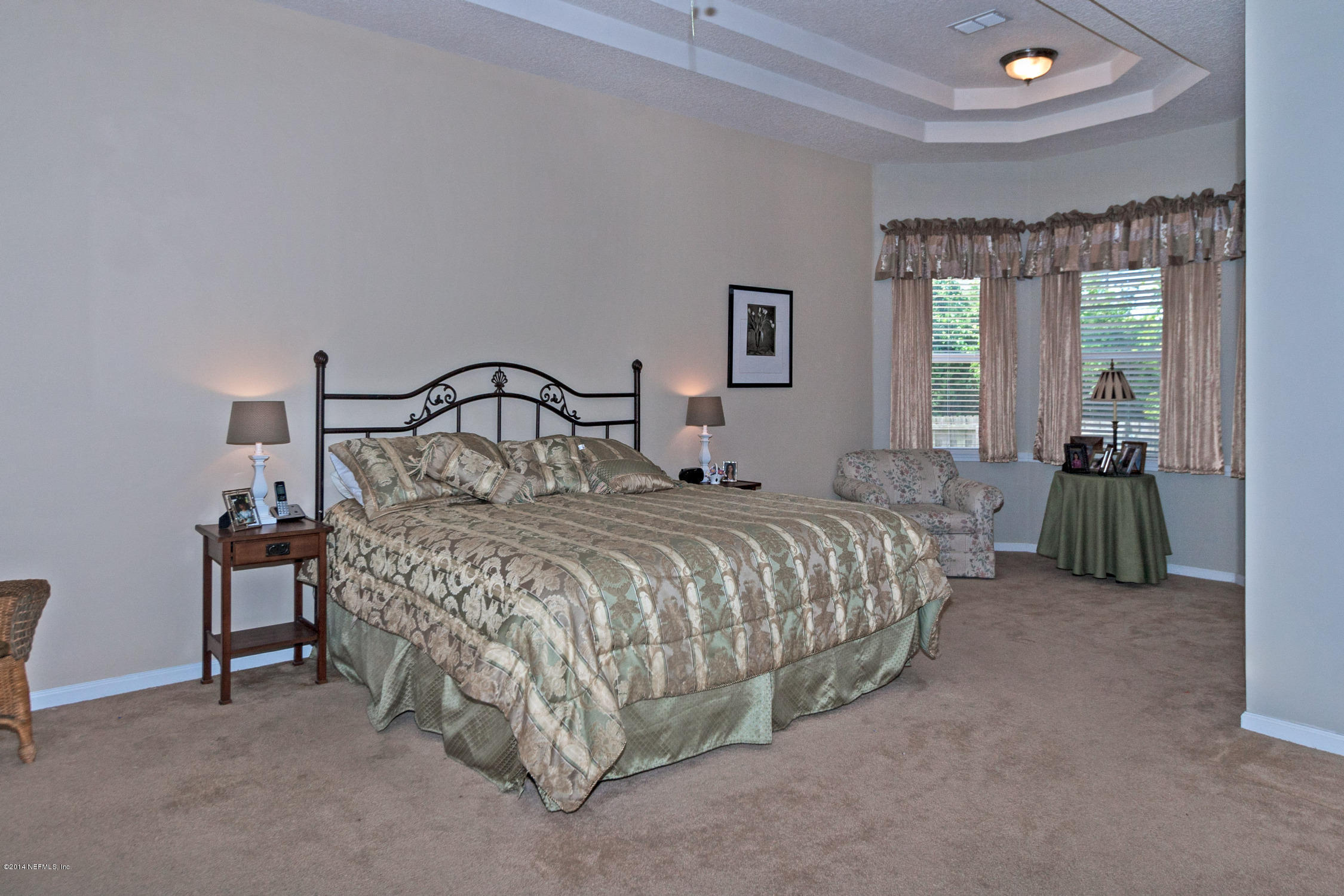 773 West Devonhurst Lane Ponte Vedra, FL 32081 - Photo 9 of 16 a bedroom with a bed and large windows