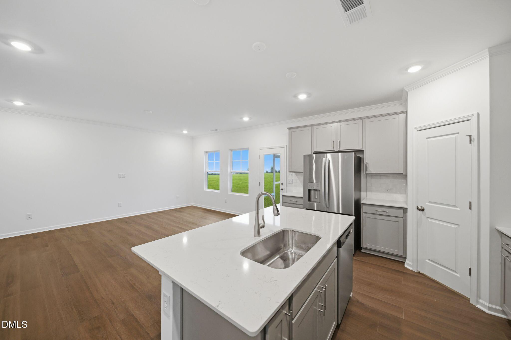 5842 Millstone Way Sims, NC 27880 - Photo 5 of 22 a kitchen with stainless steel appliances granite countertop a sink and a refrigerator