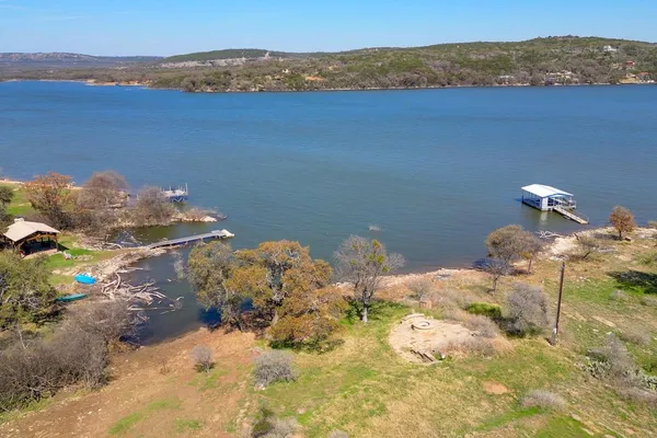 an aerial view of residential house with outdoor space and trees all around