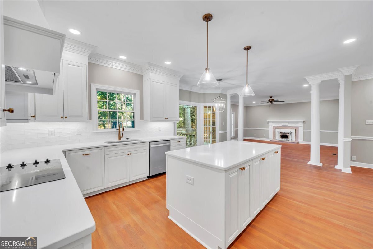 1015 Cherokee Road Perry, GA 31069 - Photo 11 of 71 a large kitchen with stainless steel appliances granite countertop a sink a stove and a wooden floors