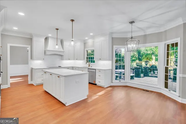 a kitchen with cabinets appliances a sink and a window
