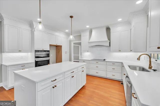 a view of white cabinets and a wooden floor