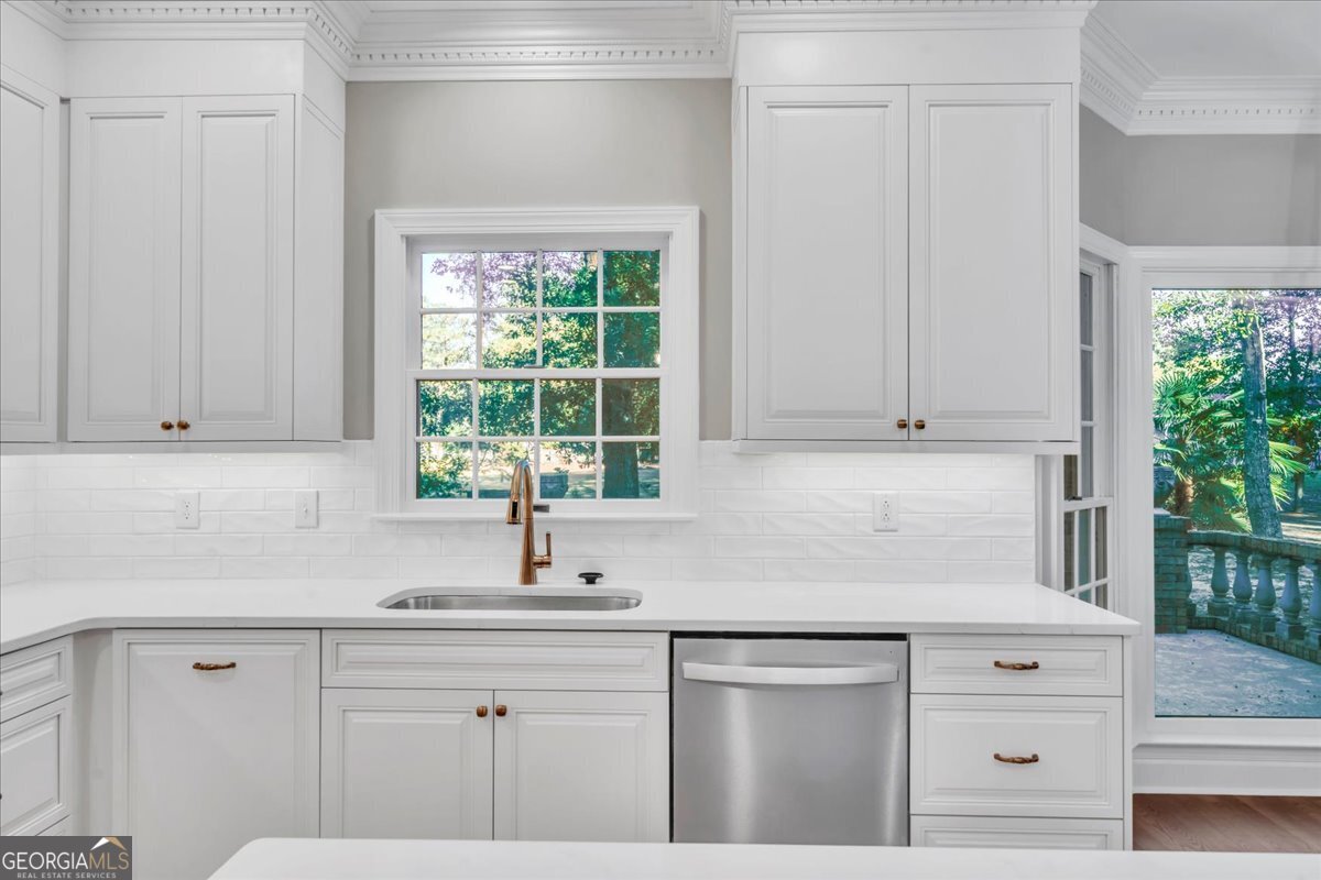 1015 Cherokee Road Perry, GA 31069 - Photo 15 of 71 a kitchen with cabinets appliances a sink and a window