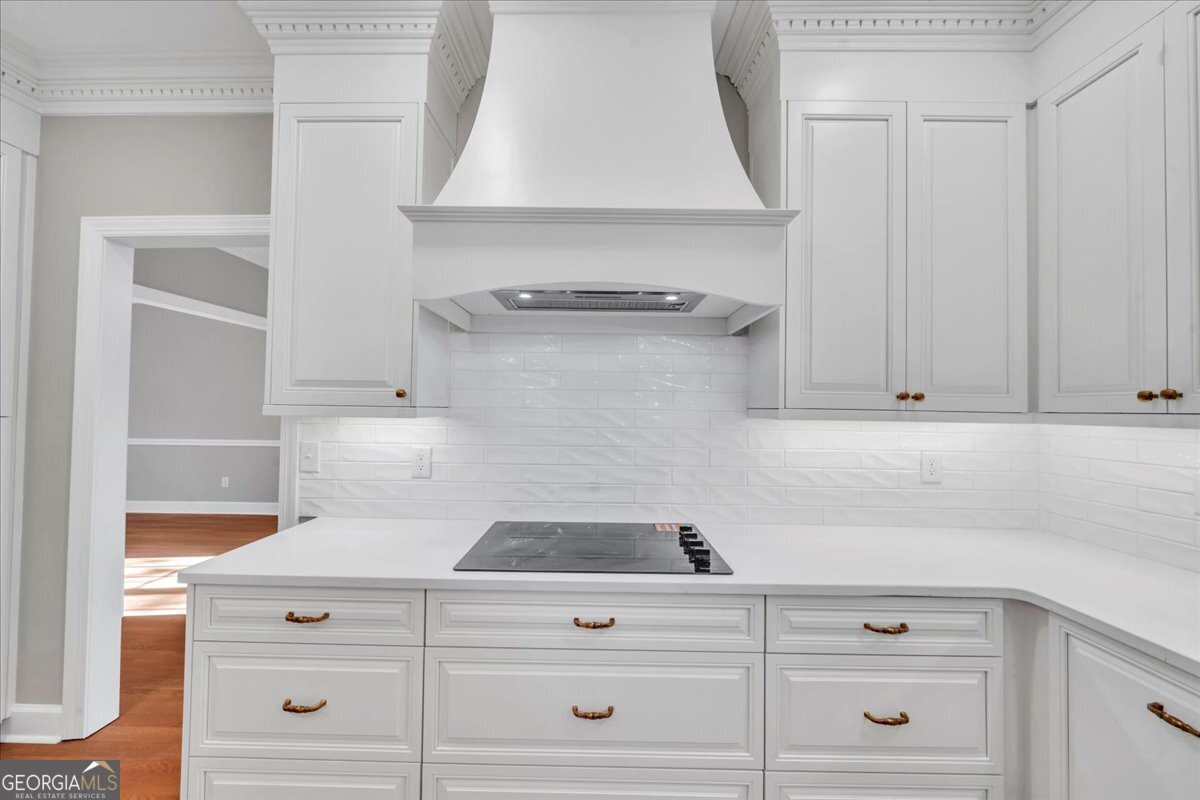 1015 Cherokee Road Perry, GA 31069 - Photo 16 of 71 a view of white cabinets and a wooden floor