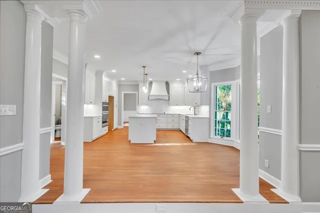 a view of an empty room with a kitchen