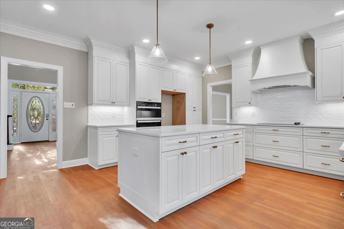 1015 Cherokee Road Perry, GA 31069 - Photo 22 of 71 a kitchen with white cabinets and stainless steel appliances