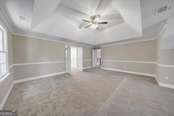 a spacious bathroom with a granite countertop tub a double vanity sink and a window
