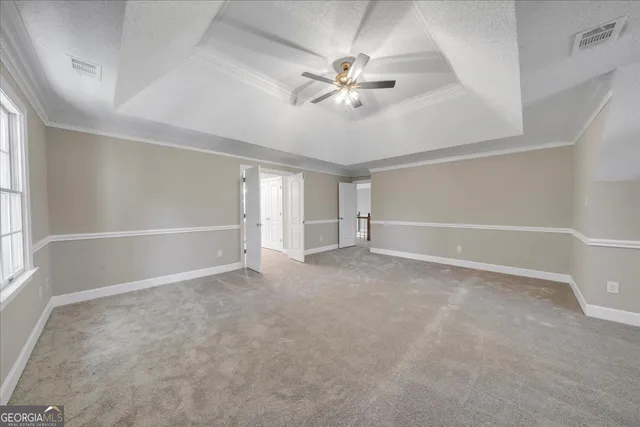 a spacious bathroom with a granite countertop tub a double vanity sink and a window