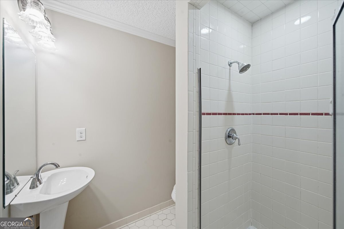 1015 Cherokee Road Perry, GA 31069 - Photo 64 of 71 a bathroom with a sink a toilet and shower