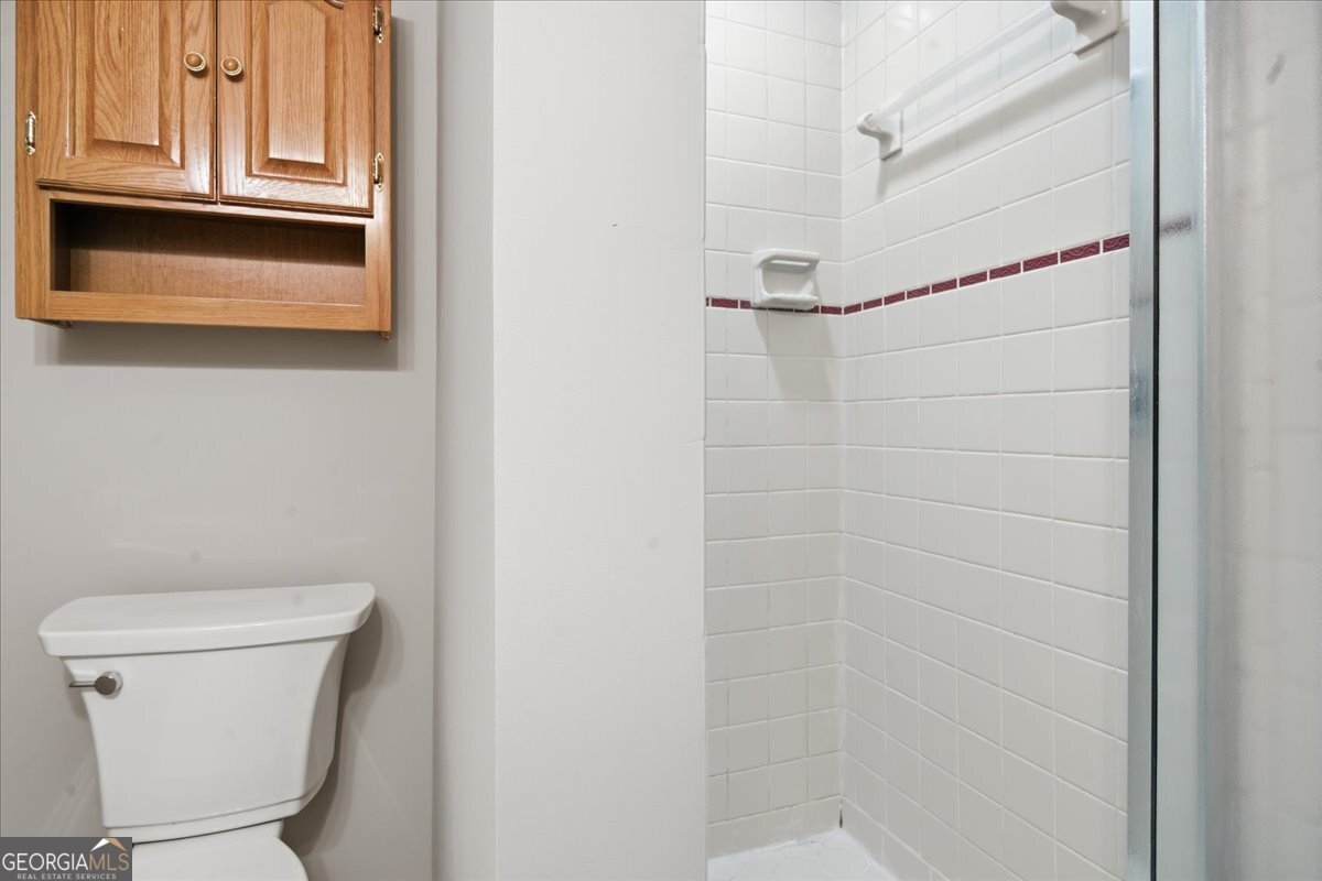 1015 Cherokee Road Perry, GA 31069 - Photo 66 of 71 a bathroom with a toilet and a shower