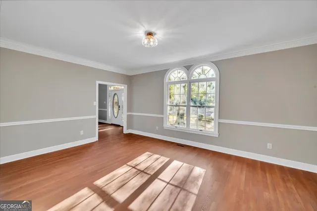 a large kitchen with stainless steel appliances granite countertop a sink a stove and a wooden floors