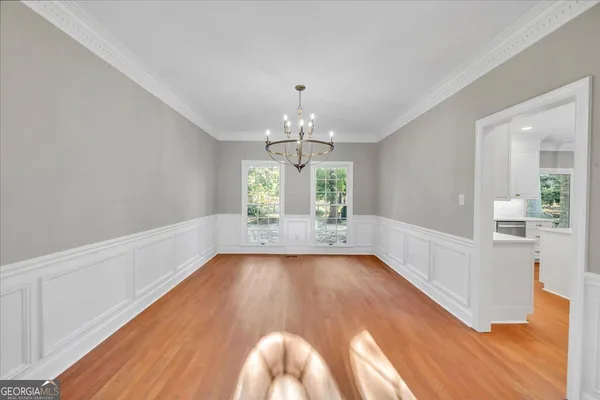 a large kitchen with kitchen island a large counter top space a sink stainless steel appliances and cabinets