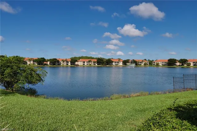 a view of a lake with houses in the back