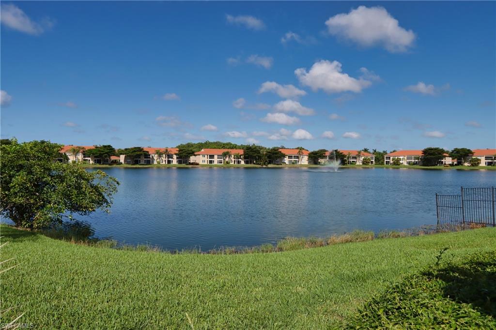 6544 Huntington Lakes Circle, Unit 9204 Naples, FL 34119 - Photo 1 of 31 a view of a lake with houses in the back