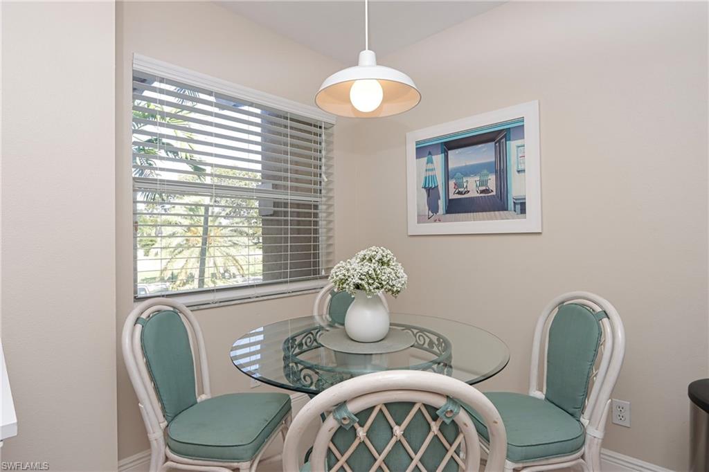 6544 Huntington Lakes Circle, Unit 9204 Naples, FL 34119 - Photo 11 of 31 a dining room with furniture and window