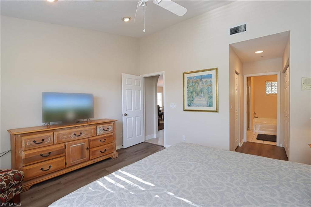 6544 Huntington Lakes Circle, Unit 9204 Naples, FL 34119 - Photo 13 of 31 a living room with furniture and flat screen tv
