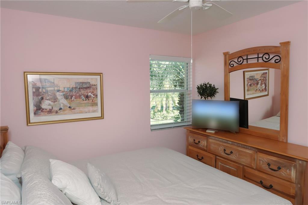6544 Huntington Lakes Circle, Unit 9204 Naples, FL 34119 - Photo 16 of 31 a living room with furniture and a flat screen tv