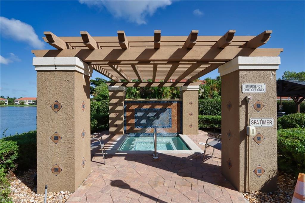 6544 Huntington Lakes Circle, Unit 9204 Naples, FL 34119 - Photo 26 of 31 a view of a patio with table and chairs potted plants