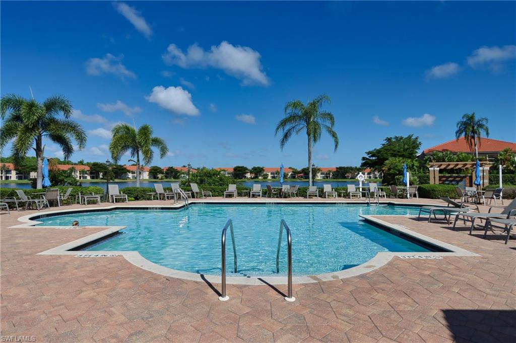 6544 Huntington Lakes Circle, Unit 9204 Naples, FL 34119 - Photo 28 of 31 a view of a swimming pool with lounge chairs