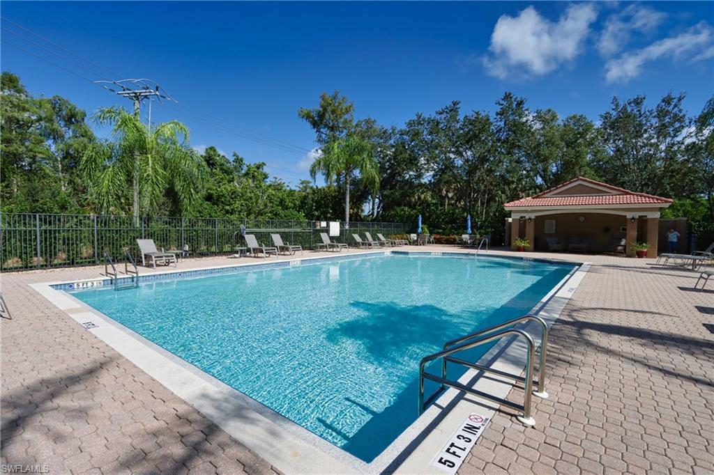 6544 Huntington Lakes Circle, Unit 9204 Naples, FL 34119 - Photo 29 of 31 a view of a swimming pool with a yard