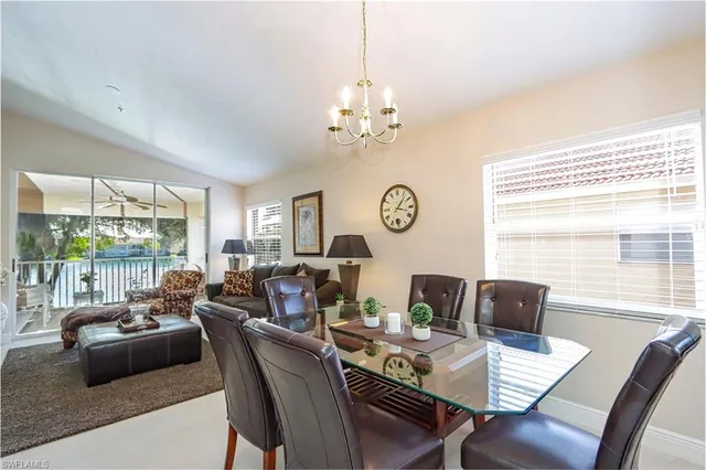 a view of a dining room with furniture and chandelier