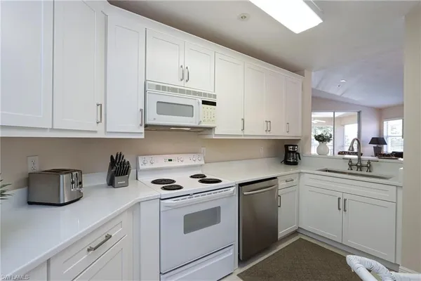 a kitchen with a stove and white cabinets