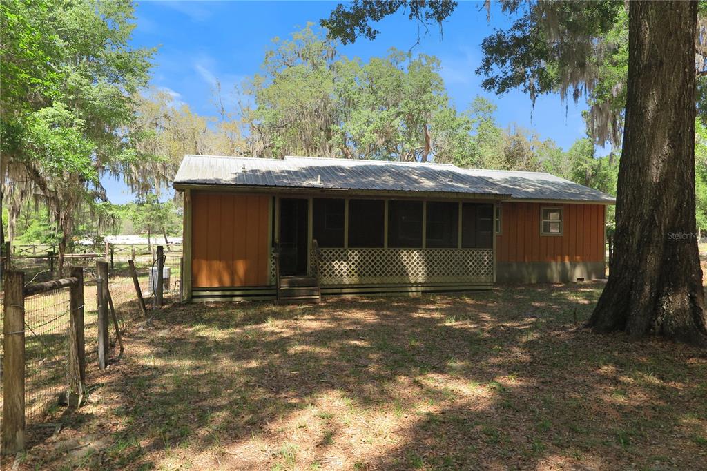 153-UNIT Ranch Road San Mateo, FL 32187 - Photo 7 of 34 a front view of a house with a garden