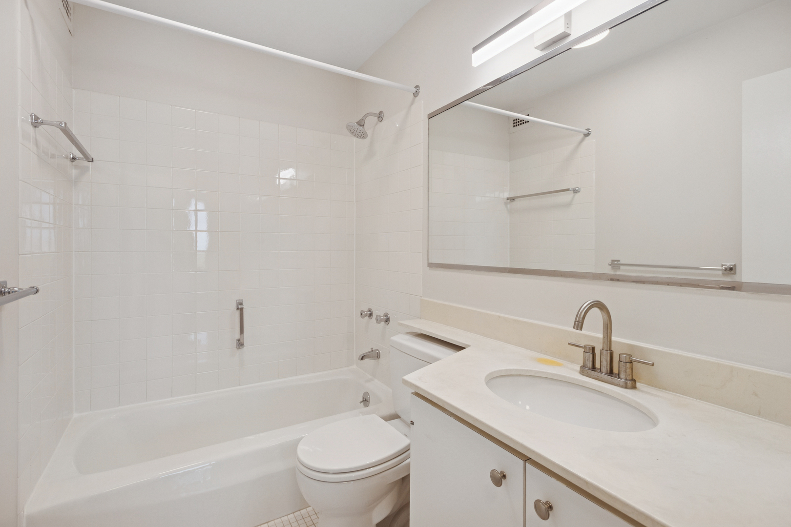 1560 North Sandburg Terrace, Unit 1412 Chicago, IL 60610 - Photo 11 of 16 a bathroom with a sink toilet and shower