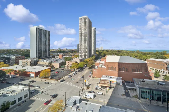a view of city with lawn chairs and ocean view