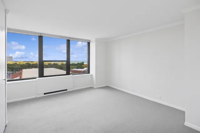 an empty room with large windows