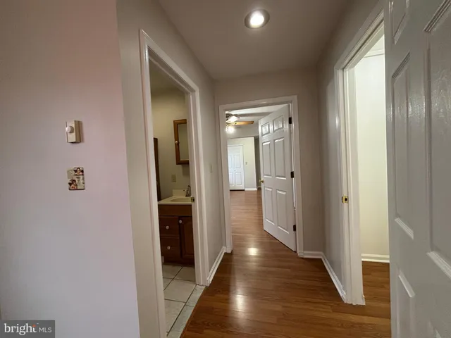a view of a hallway with wooden floor