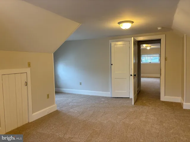 an empty room with closet and a bathroom