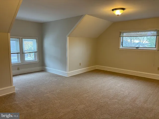 an empty room with a empty space and windows