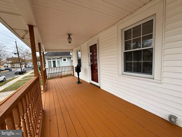a view of outdoor space with wooden floor and windows