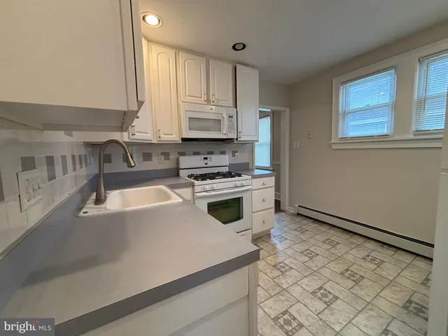 a kitchen with a stove a sink and a refrigerator