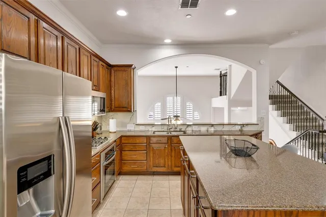 a kitchen with a sink a stove cabinets and a living room view