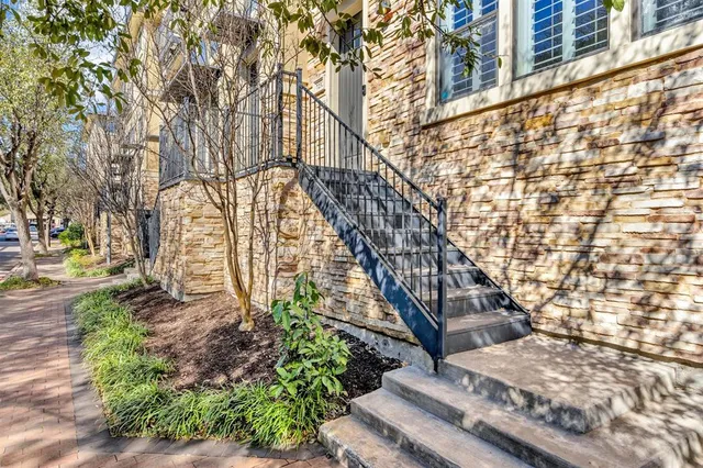 a living room with a couch and a potted plant